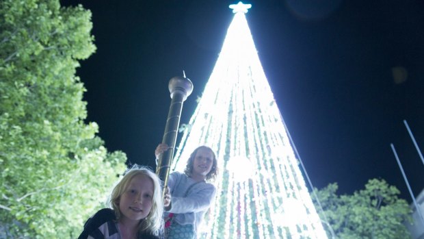 Edi Lupton, 9, and Cat Lupton 11 beneath the record-breaking light-covered Christmas tree.
