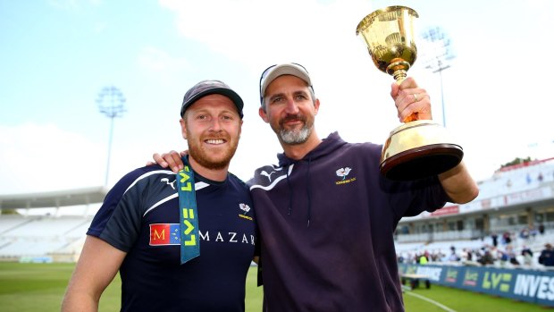 Rewards: Captain Andrew Gale and Gillespie hold last year's trophy aloft.