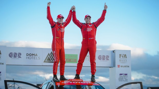 Canberran Harry Bates and Queenslander John McCarthy celebrate their victory in the National Capital Rally on top of their Toyota Corolla. Photo: Sitthixay Ditthavong