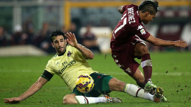 Adil Rami fights for the ball with Torino's Josef Alexander.