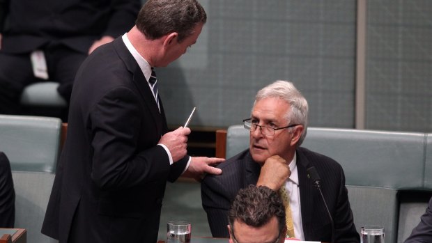 Leader of the House Christopher Pyne speaks with Liberal MP Don Randall during question time in 2013.