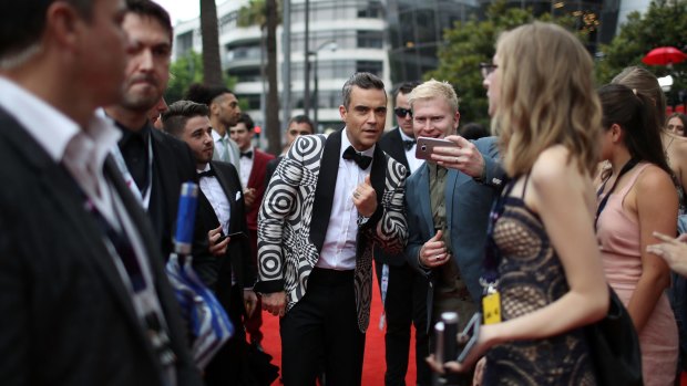 Canberra developer Bill O'Neill was captured by a press photographer getting his selfie with Robbie Williams at the ARIAs.
