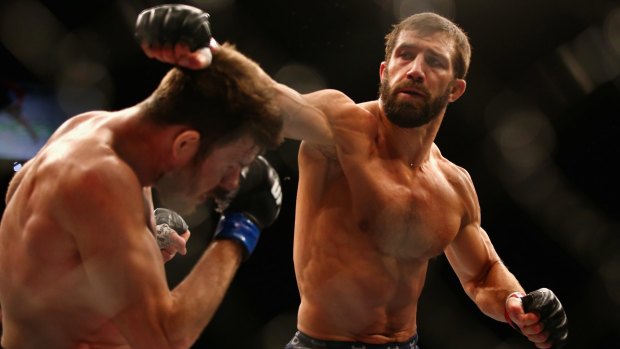 Missed me: Michael Bisping ducks a punch from Luke Rockhold during their middleweight fight at UFC Fight Night 55.
