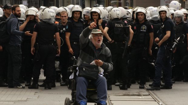 Dissenter: A man protests in front of a police line in Istanbul's Taksim Square, marking the first anniversary of the 2013 Gezi Park protests.
