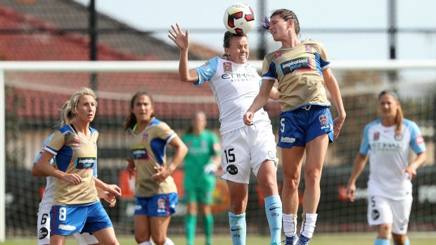 Tight tussle: City's Amy Jackson heads clear from Jets' Erin Gilliland.