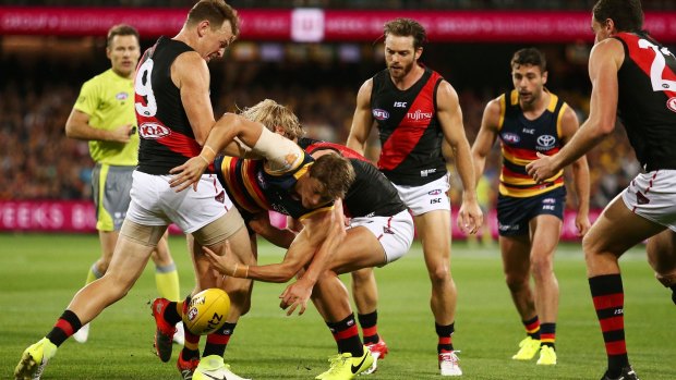 Crow sandwich: Matt Crouch is tackled by Brendon Goddard (left) and Darcy Parish. 