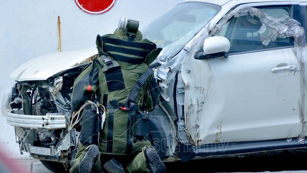 A Maldives bomb squad member checks a suspected explosive inside the engine compartment of a parked broken car in Male, capital of the Maldives, on Wednesday. 