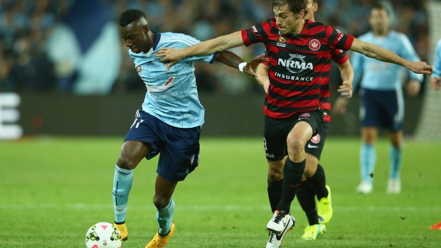 Demolition derby: Mateo Poljak (right) does battle with Bernie Ibini during the first Sydney derby.