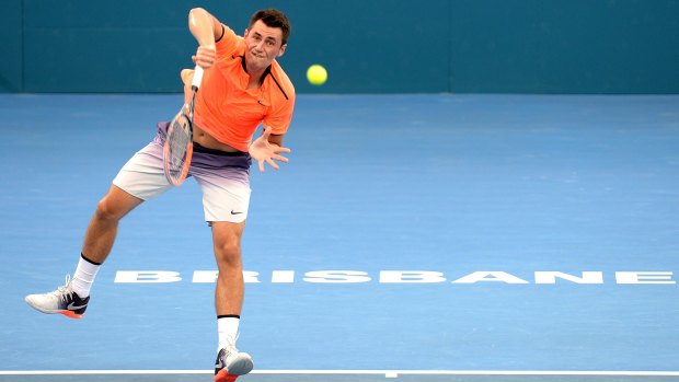 First-round exit: Tomic serves against Spaniard Ferrer.
