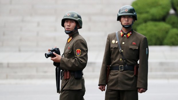 North Korean soldiers look across to the South Korean side of the truce village of Panmunjom in the Demilitarised Zone.