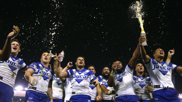 The Bulldogs team sing their team song in front of the crowd on the hill as they celebrate victory during the round 16 NRL match between Canterbury and the Melbourne Storm at Belmore Sports Ground on June 29, 2015.  
