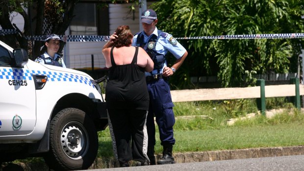Police speak to a neighbour on Edgeworth Street after Michael Moad was killed.