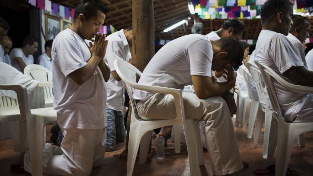 Alzimar Coelho, left, prays after after consuming ayahuasca, a psychedelic brew used in the Amazon basin for centuries, during a ceremony at a temple on the outskirt of Ji-Parana, Brazil.