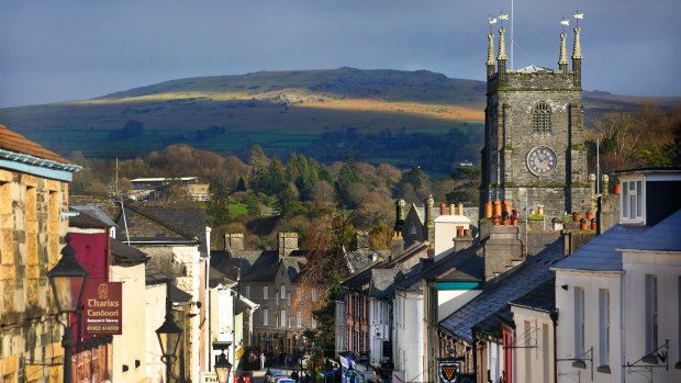 West Street in Tavistock, Devon, showing Tavistock Parish Church, with Dartmoor National Park in the background.