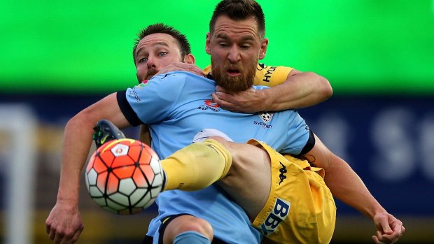 In another life: Shane Smeltz does battle with Joshua Rose of the Mariners during his time with Sydney FC.