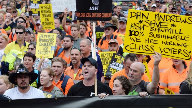 Log trucks parked around State Parliament to protest the closure of the Heyfield Timber Mill in March.