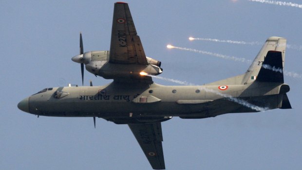 In this October 2009 file photo, an Indian Air Force AN-32 transport aircraft releases chaff as it flies past the IAF Day Parade in New Delhi, India. 