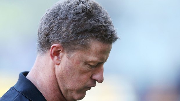 Down and out: Tigers coach Damien Hardwick leaves the field after the three-quarter-time break.