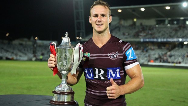 First piece of silverware: Daly Cherry-Evans  collects the Community Cup after the Sea Eagles beat the Roosters in their trial in Gosford.