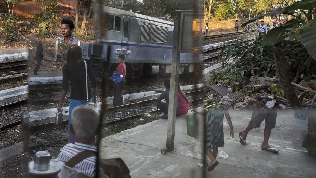 People arrive at the Phaya Lan train station in downtown Yangon, Myanmar.