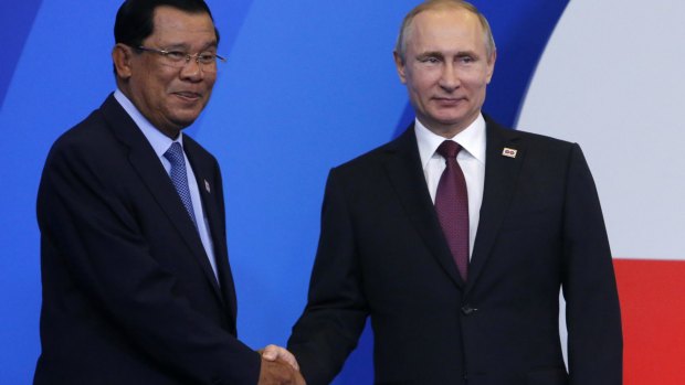Cambodian Prime Minister Hun Sen, left, shakes hands with Russian President Vladimir Putin  at the ASEAN-Russia summit in Sochi, Russia, on May 20.