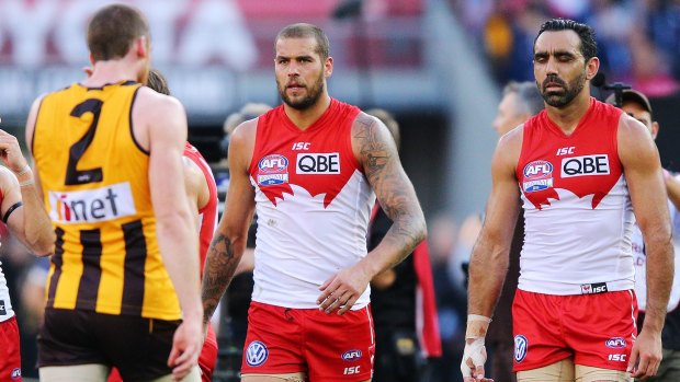 Swan dive: Lance Franklin and Adam Goodes leave the MCG after losing the 2014 grand final to Hawthorn.