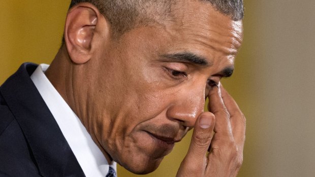 An emotional President Barack Obama pauses to wipe away tears as he recalled the 20 first-graders killed in 2012 at Sandy Hook Elementary School.