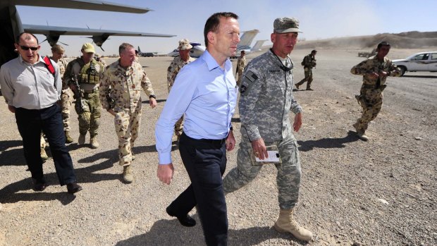Then opposition leader Tony Abbott is greeted by Colonel Jim Creighton at the Tarin Kowt base in Afghanistan.
