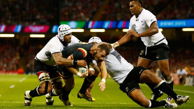 Gareth Davies gets held up by Fiji before the line in the second half.