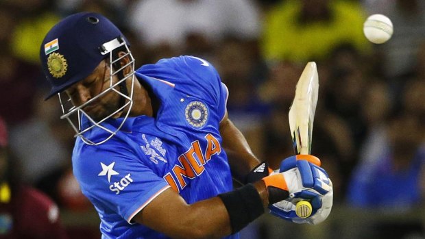 India's Suresh Raina ducks to avoid a bouncer from Andre Russell.