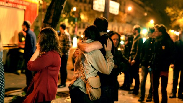 People outside the Bataclan concert hall after the attack. One of the terrorists told victims, "This is the fault of your president; he didn't have to intervene in Syria".
