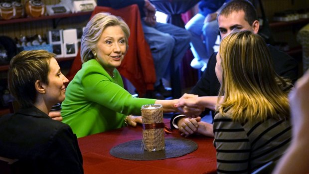 Former US secretary of state Hillary Clinton talks with local residents as she campaigns at the Jones Street Java House in LeClaire, Iowa.