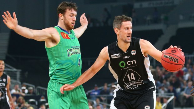 Daniel Kickert of Melbourne United controls the ball as Nicholas Kay of the Townsville Crocs defends.