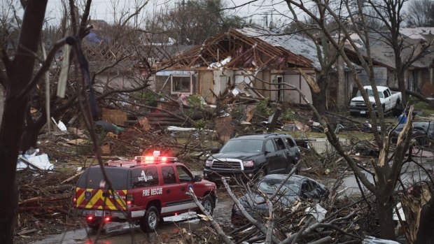 An emergency vehicle in Rowlett, Texas, on Sunday, the morning after it was struck by a tornado. 