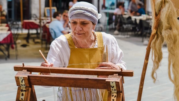 Weaving at a historic medieval festival in Perugia, Italy.