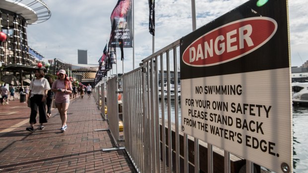 Temporary fencing and signs at Darling Harbour and King Street Wharf before New Year's Eve.