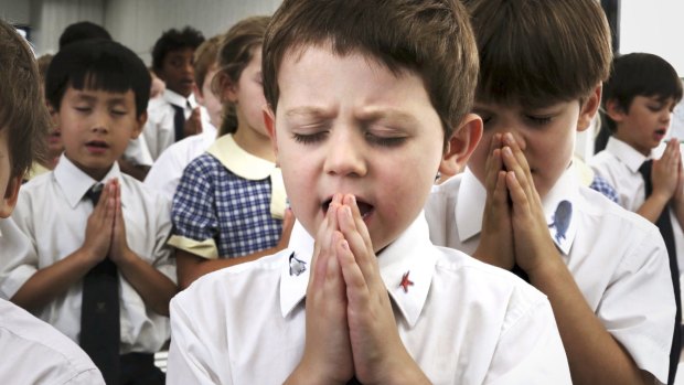 Christianity as practised in Australia includes as much as it excludes: Fraser Rowan tries his hardest during a prayer session at John Colet school in Belrose.