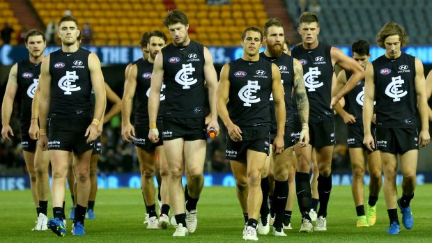 Dejected: The Blues leave the field after losing to the previously winless Brisbane Lions at Etihad Stadium on Sunday. 