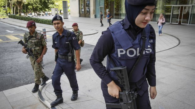 Malaysian military and police patrol  outside a shopping mall in Kuala Lumpur.