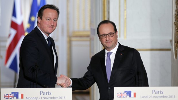 British Prime Minister David Cameron shakes hand with French President Francois Hollande after a press conference at the Elysee Palace on Monday. 