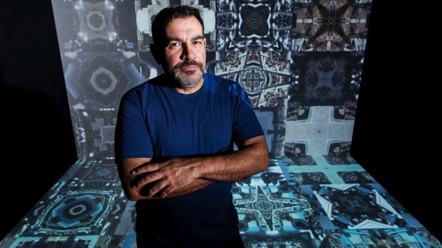  Artist Khaled Sabsabi in front of his giant mosaic video work Syria.