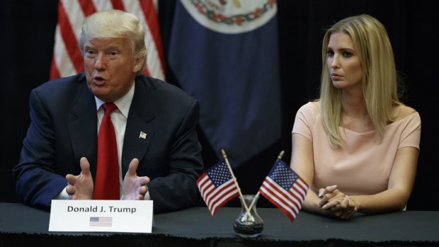 Ivanka Trump listens as her father Donald speaks at a roundtable discussion.