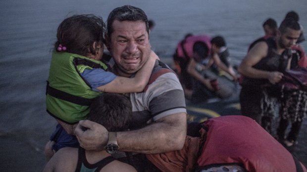 Laith Majid, from Deir al-Zor in Syria, bursts into tears after arriving on Kos with his children in August. 