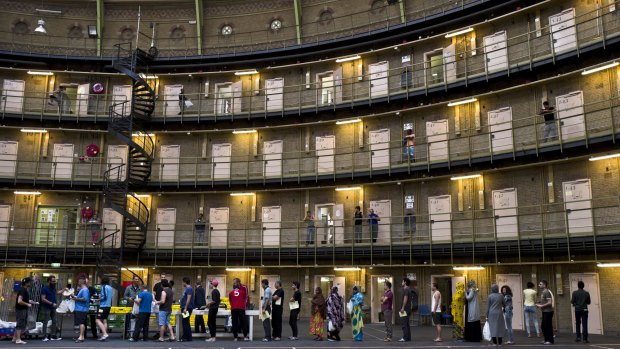 Refugees and migrants line up for lunch at the former prison of De Koepel in Haarlem, Netherlands.