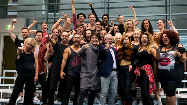 Writer and director Ben Elton (front row, in blue jacket) with the cast of We Will Rock You, in  Sydney.