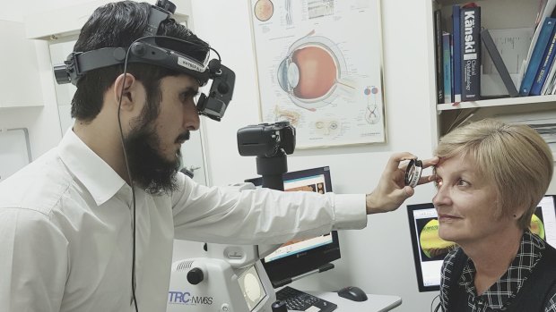 Optometrist Khyber Alam with a patient.
