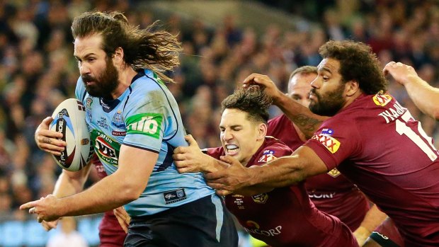 Room for improvement: Aaron Woods scores a try through the middle of the Queensland defence.