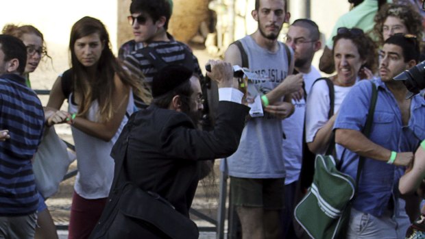 Yishai Schlissel charges at spectators with a knife at the Jerusalem Gay Pride Parade on July 30.