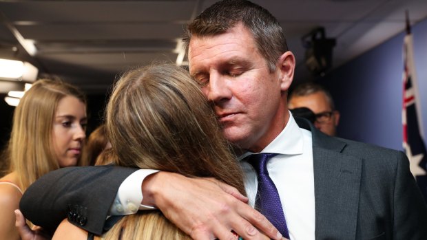 Premier Mike Baird hugs his daughter after a press conference announcing his resignation in Sydney. 