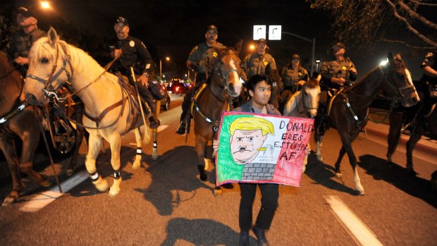 Police on horseback clear the anti-Trump demonstrators after a rally in Costa Mesa.